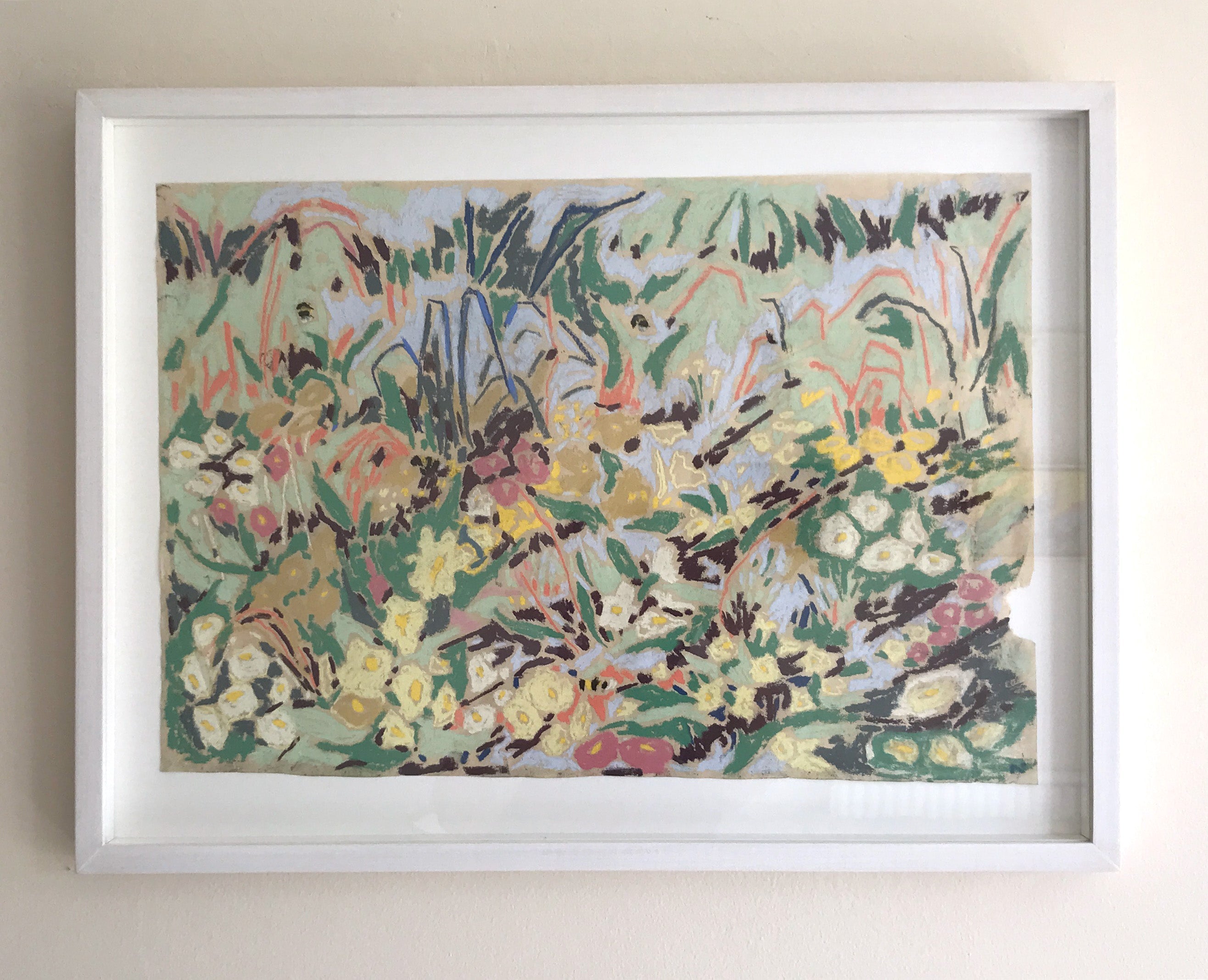Bees and primroses by Sally Newton. Framed abstract artwork with colourful patterns on a beige wall.