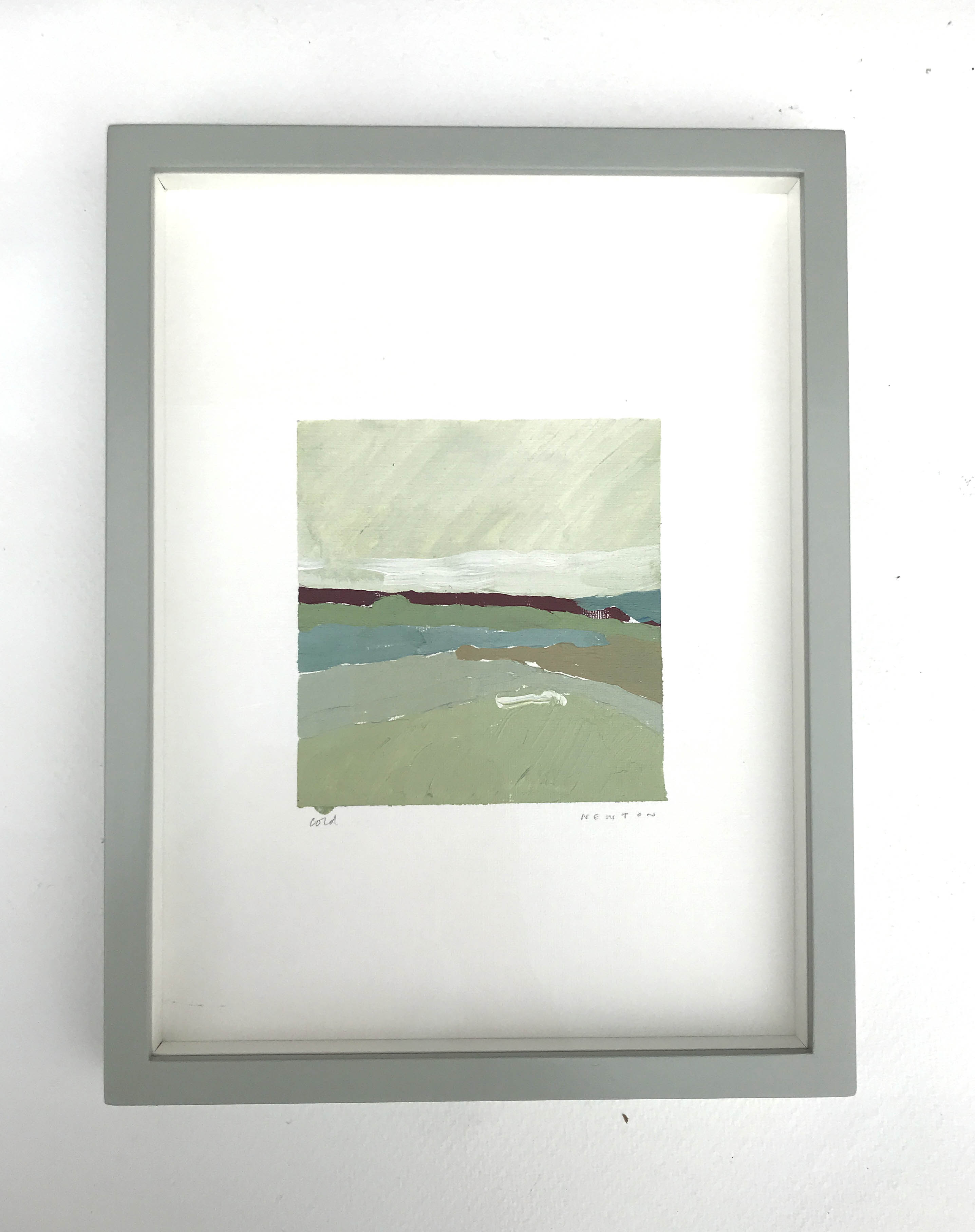 Cold by Sally Newton. Framed artwork with a landscape scene on a white wall.
