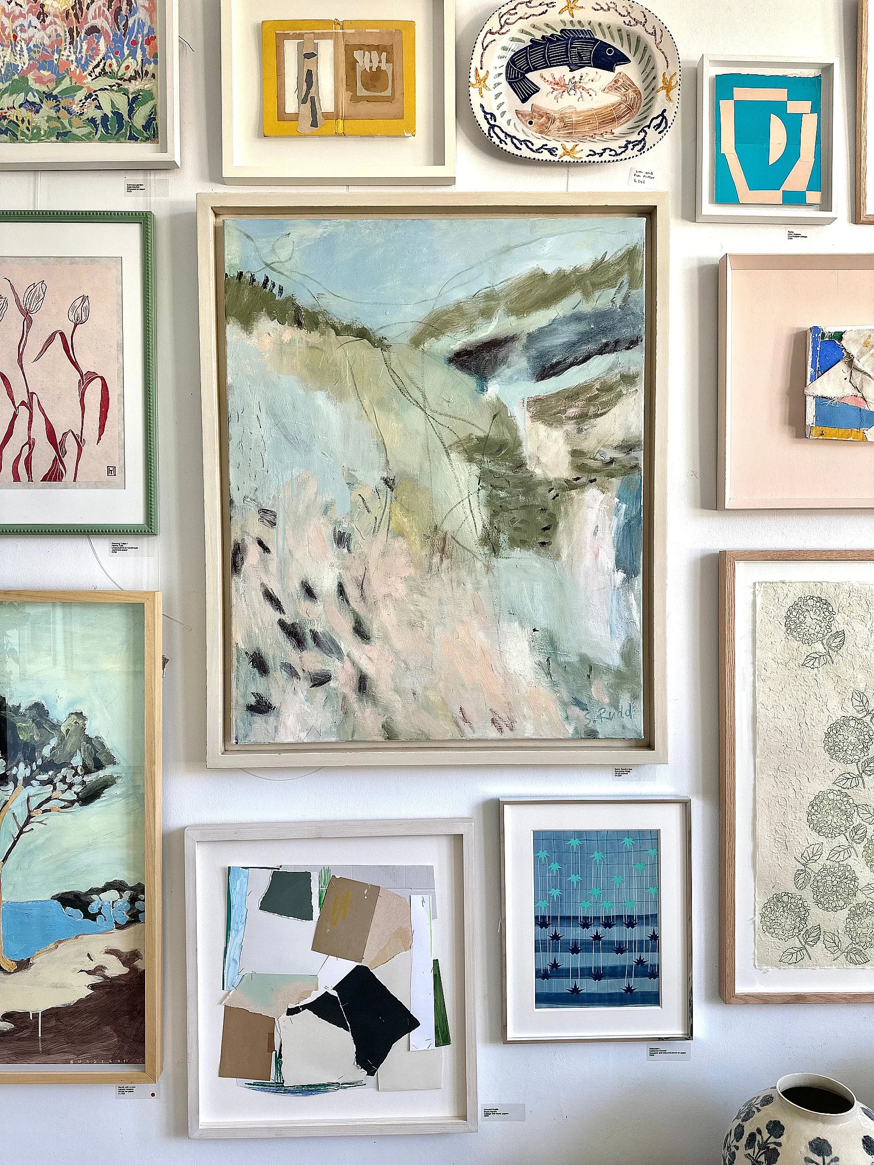 Saint, Sand & Sea by Samantha Rudd, hung on wall with various framed artworks and decorative items