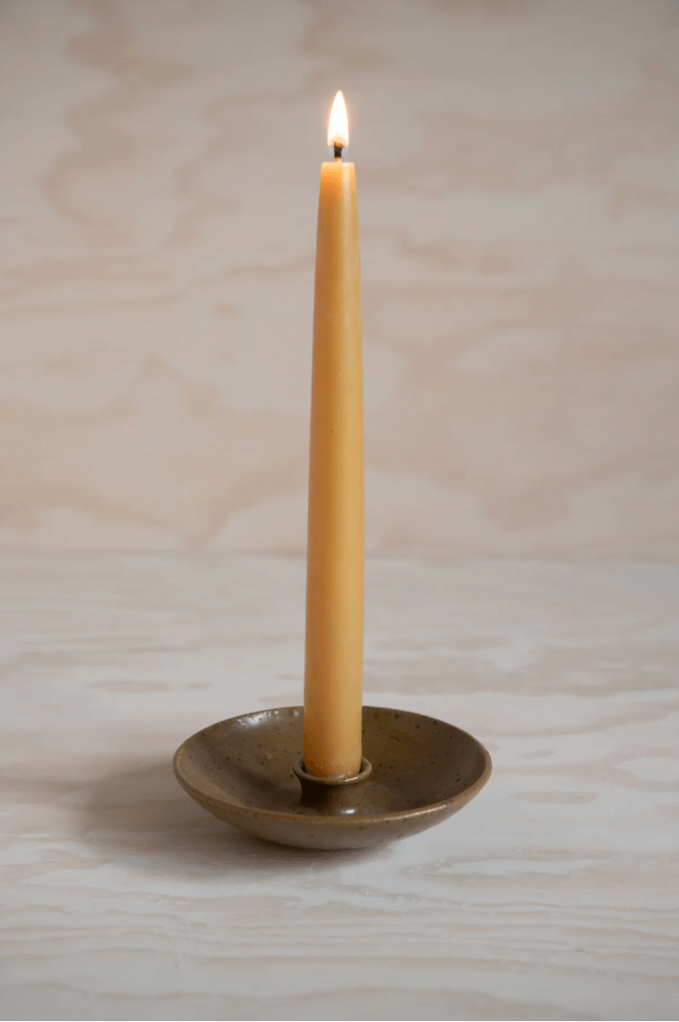 'Skylark' candlestick holder with orange candle by ceramicist Charlie Maw
