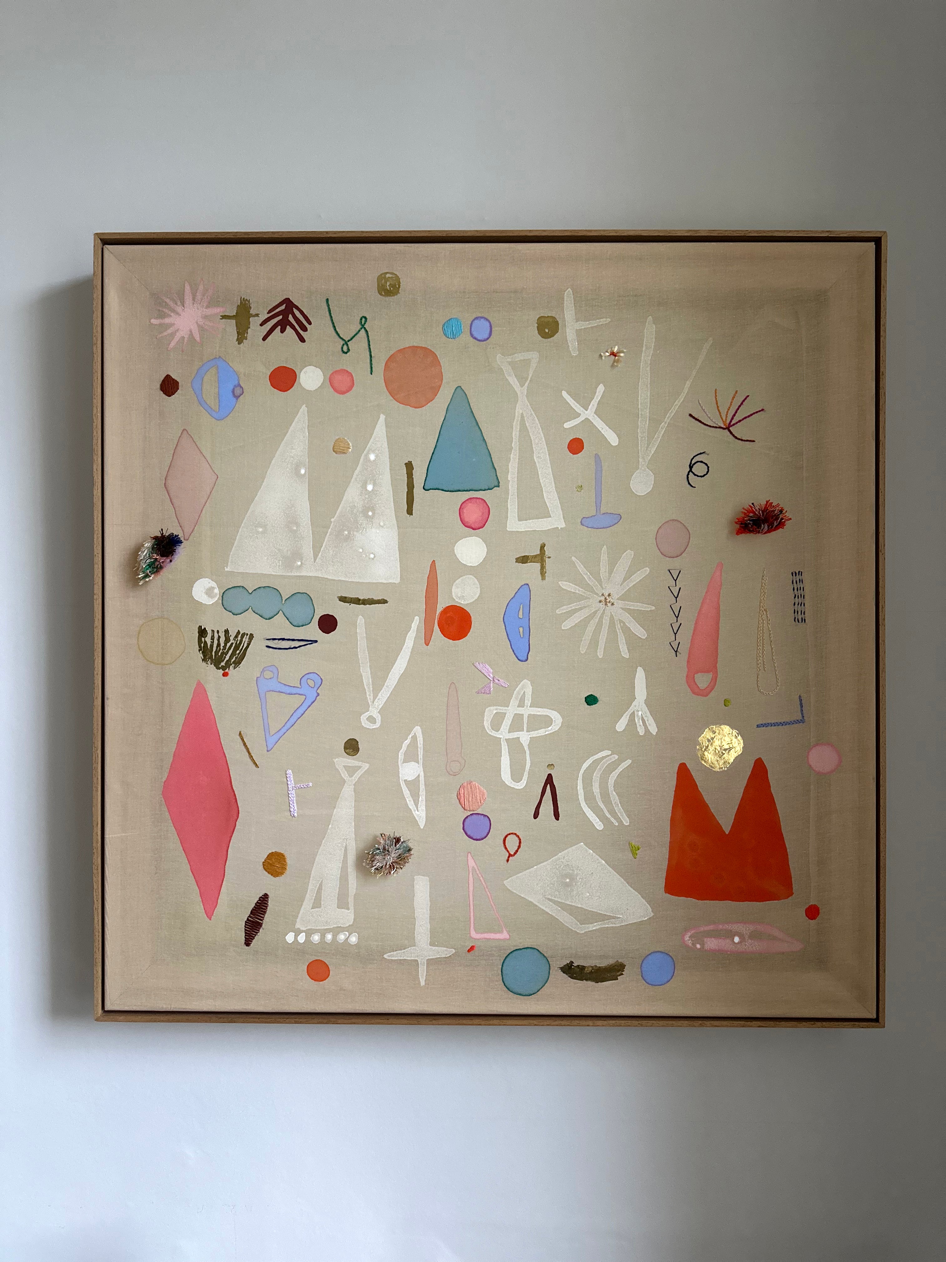 Abstract artwork with geometric shapes on a beige background, framed in brown.