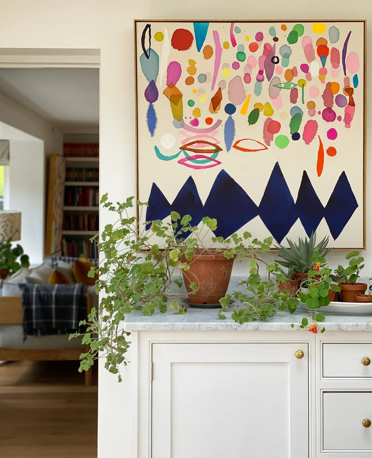 Large colourful abstract by Becky Blair on white walls of Hampshire farmhouse kitchen by art advisory