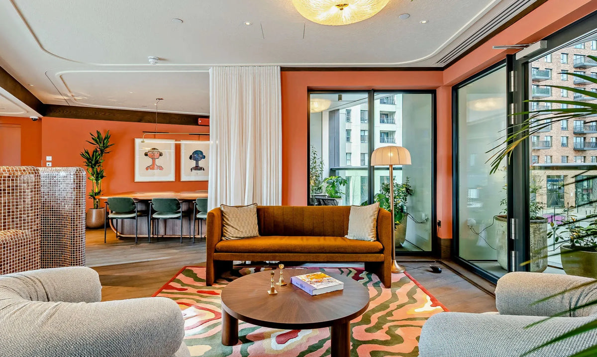 Iona Stern heads framed artwork on orange walls branded living Riverstone Heights London adc tunea and Mylo art consultancy