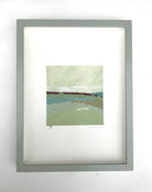 Cold by Sally Newton. Framed artwork with a landscape scene on a white wall.
