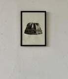 Jelly Mold II by Sophie Cole. Framed black and white print of a jelly mould on a plain wall.