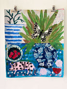 Pink Pig and Plums by Cornelia O'Donovan. Colorful artwork with a butterfly, polka dot pig, and floral elements on a blue background.