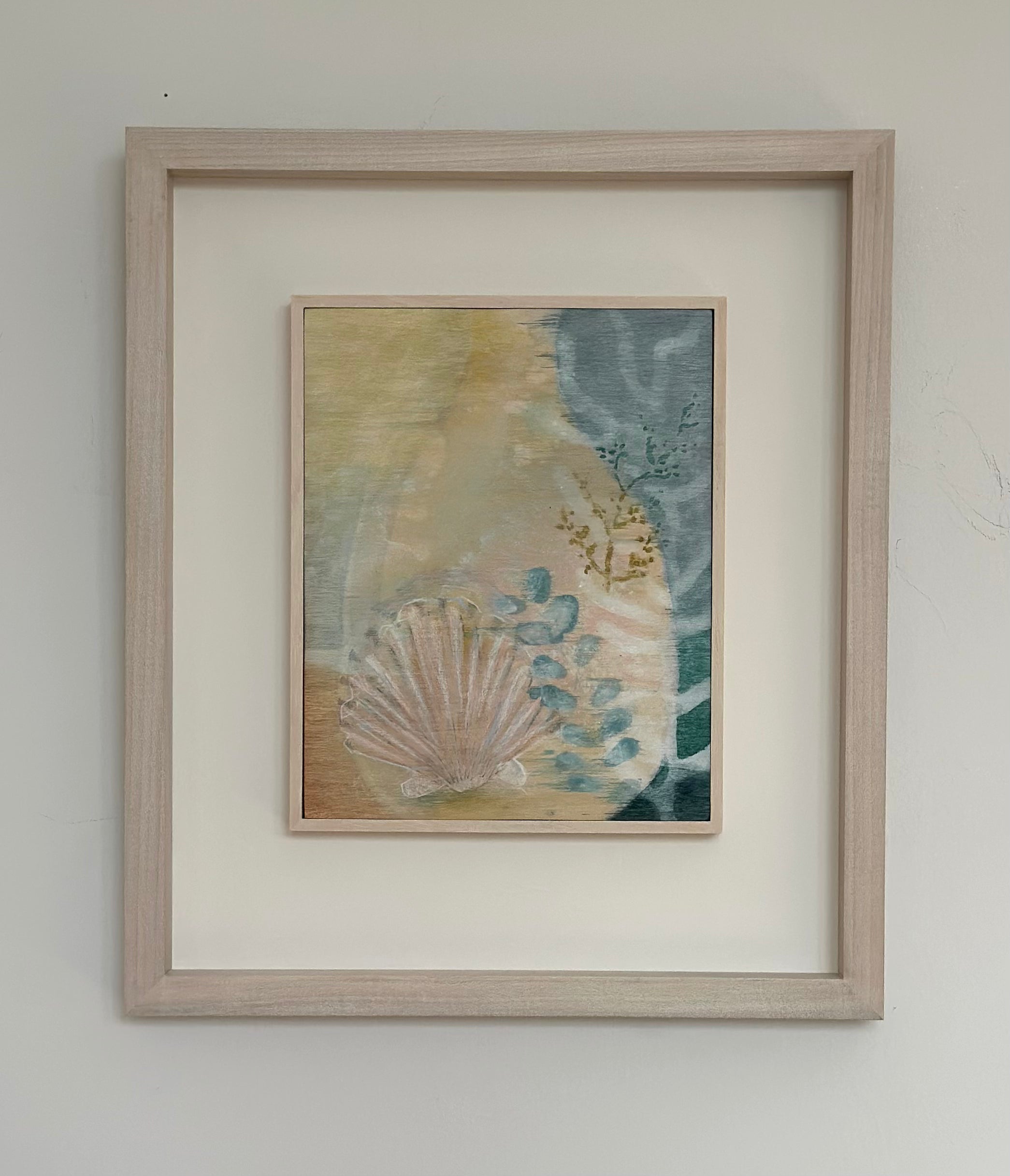 Secret Messages by Tara Leaver. Framed artwork with a shell and beach scene on a white wall.