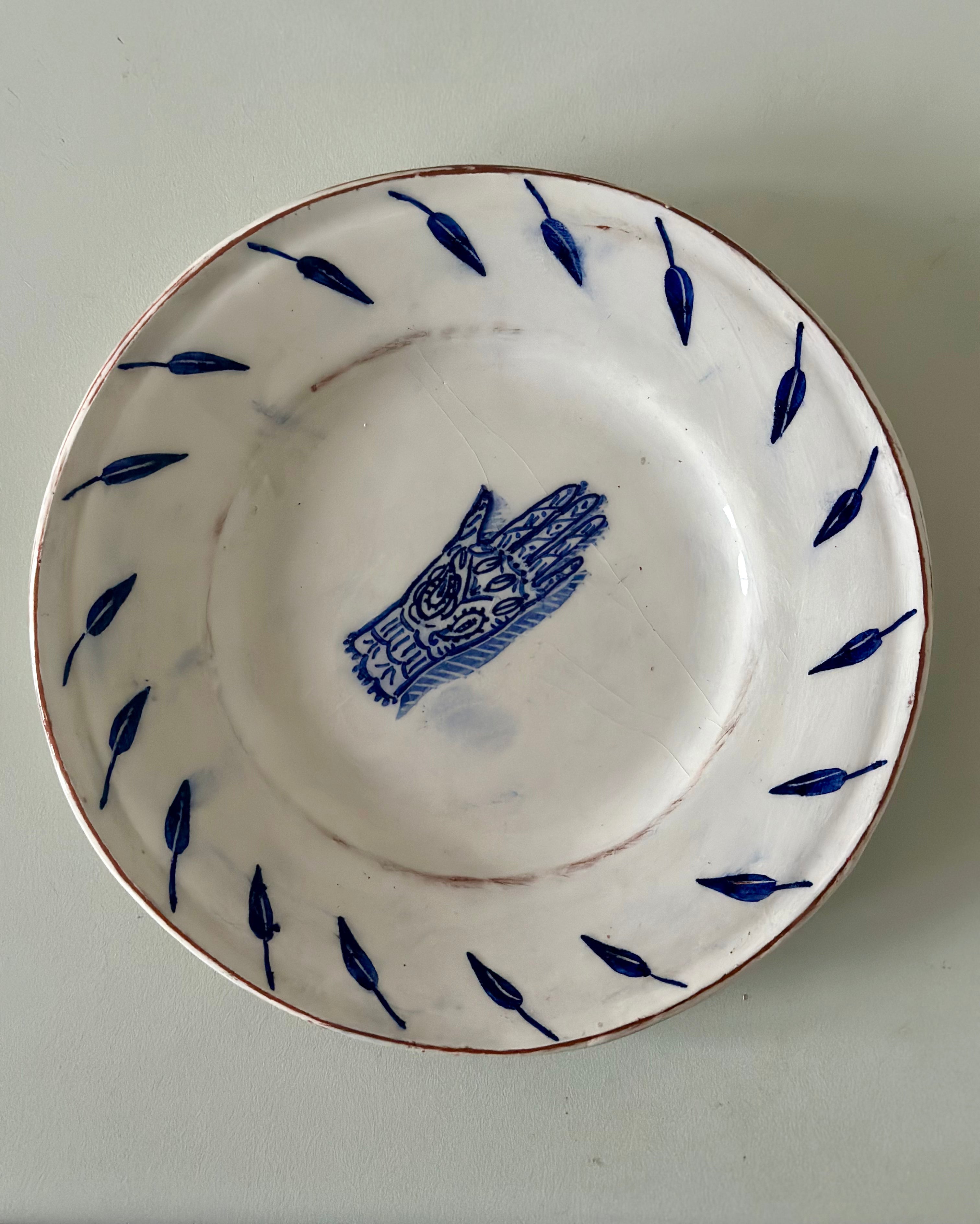 White ceramic dish with blue decorative elements on a plain background