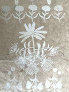 Still by Neera Sehgal depicting Indian block print white floral pattern on a textured brown background